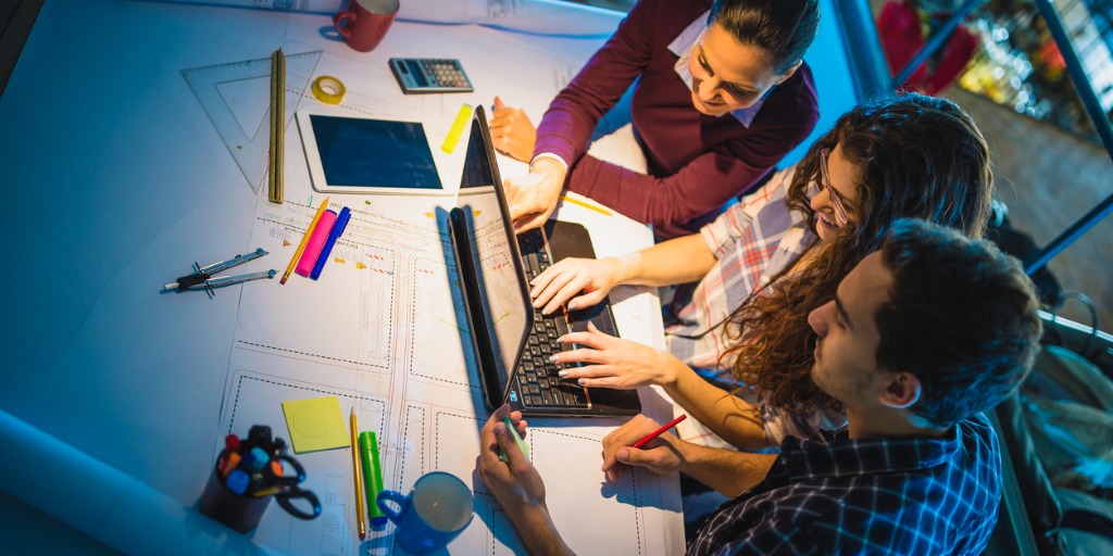 working-late-group-of-young-architects-working-late-in-office-picture-id873882140 working-late-group-of-young-architects-working-late-in-office-picture-id873882140